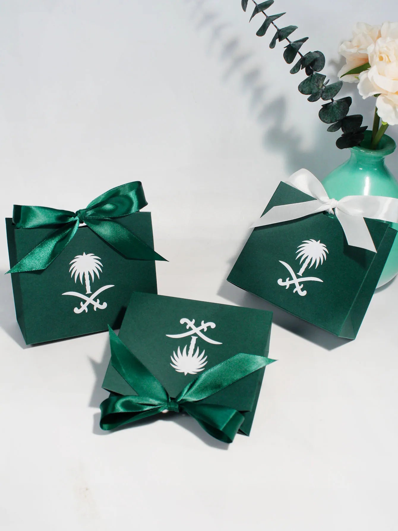 Green gift box with a palm tree design, perfect for celebrating Saudi National Day.